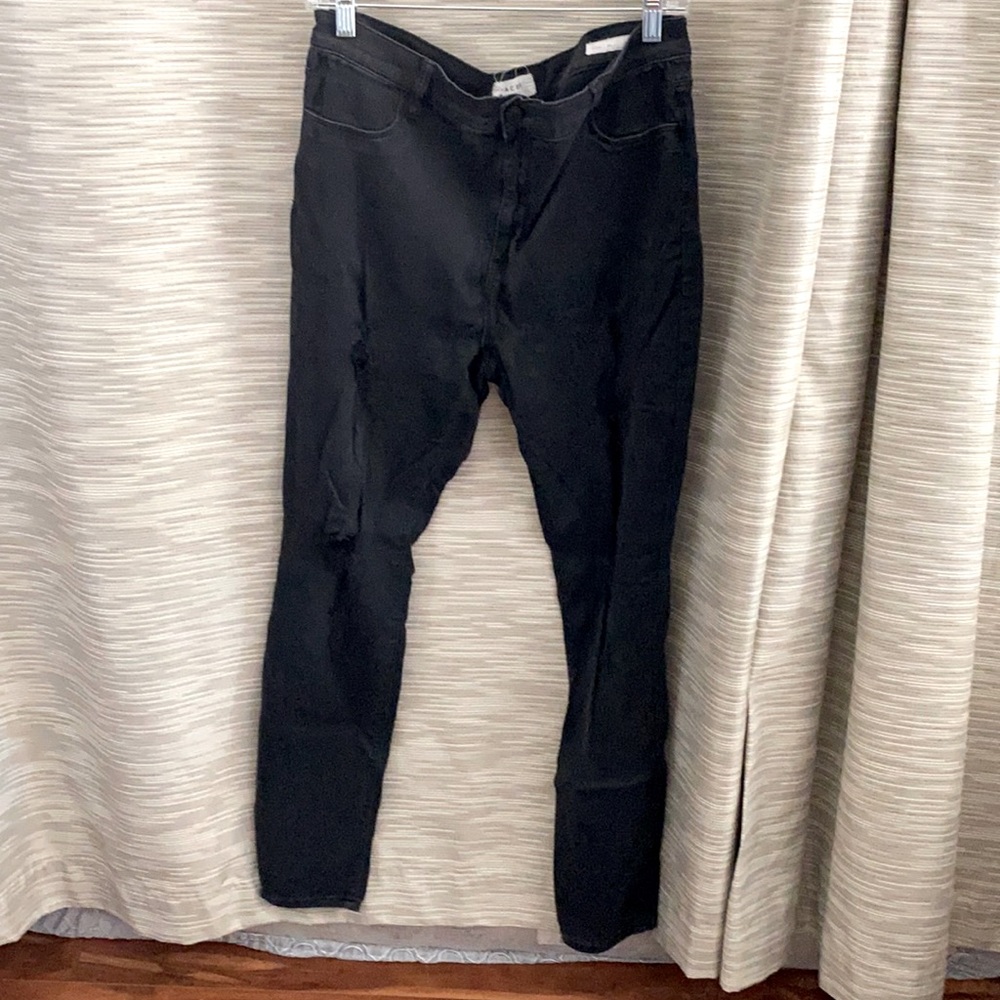 Black jeans with little rips in the thigh
